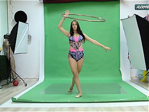 ample orbs Nicole on the green screen stretching